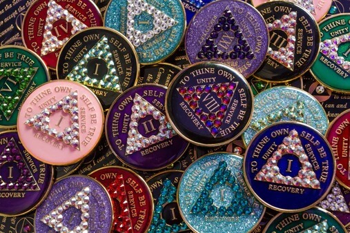 A pile of different colored and shaped coins.