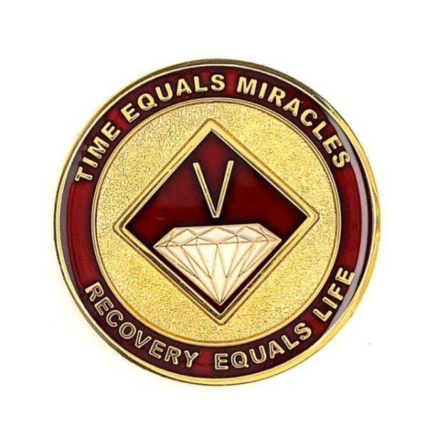 A gold and red coin with the words time equals miracles, recovery equals life.