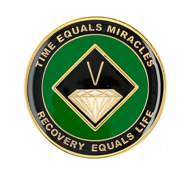A green and black coin with the words " time equals miracles recovery equals life ".