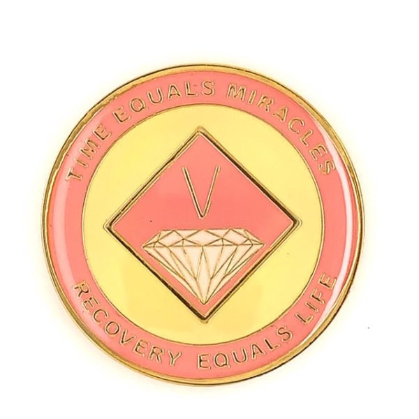 A pink and yellow diamond shaped coin.
