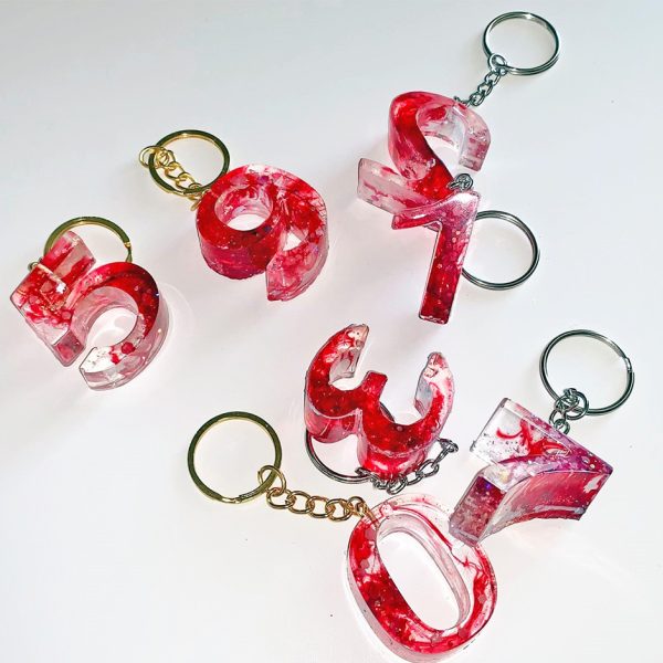 A group of red and white keychains on top of each other.