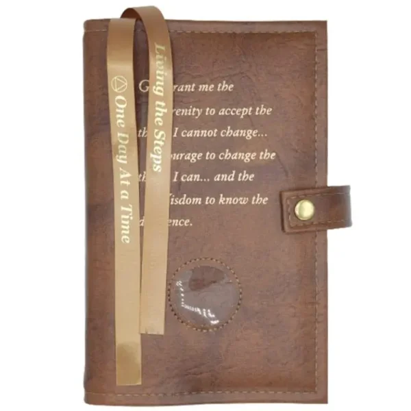 A brown leather book with gold ribbon and words.