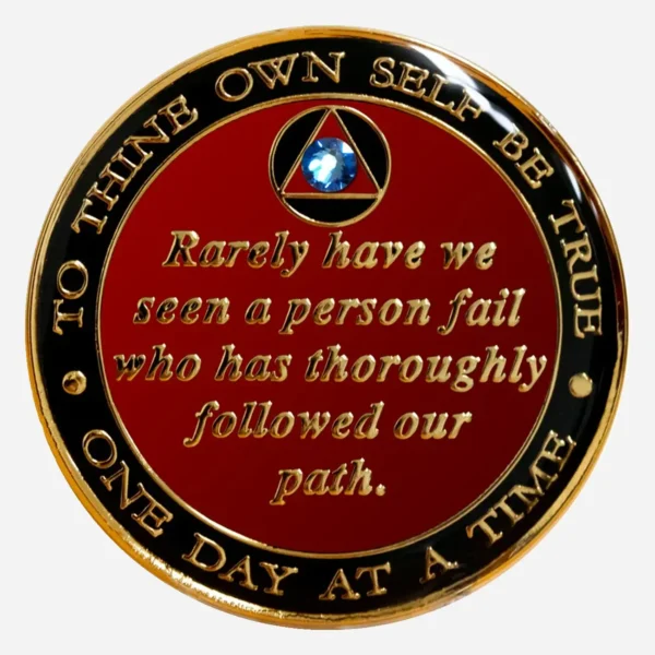The Serenity Prayer in gold on a blue AA medallion with a sapphire crystal accent.