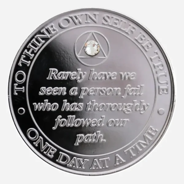 The Serenity Prayer in gold on a nickel AA medallion with a diamond crystal accent.