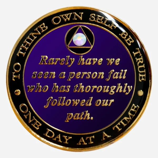 The Serenity Prayer in gold on a purple AA medallion with a crystal AB accent.