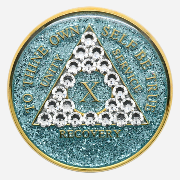 Embrace Renewal with the Crystal AA Medallion Glitter Aqua/Diamond The Crystal AA Medallion Glitter Aqua/Diamond shines as a symbol of growth and resilience on the journey of sobriety. Featuring a serene aqua background with a diamond-clear Swarovski crystal accent, each medallion is handcrafted by individuals in recovery. Available for milestones from 1 to 50 years, this medallion brings together the qualities of clarity, strength, and renewal, making it a powerful reminder of each accomplishment in recovery. Features: Material: With a genuine Swarovski crystal in diamond-clear tones set against a sparkling aqua background, this Glitter Aqua Diamond Crystal AA Medallion radiates peace and focus. Its hand-painted aqua finish is encased in a high-quality, chip-resistant resin dome to ensure lasting brilliance and durability. Front Design: The AA triangle stands proudly on the glittering aqua background, bordered by diamond-clear crystal accents around the phrase “To Thine Own Self Be True,” symbolizing authenticity and self-reflection in recovery. Roman numerals within the triangle commemorate each sobriety year, adding a personal touch that honors each milestone. Back Design: The reverse side features a single diamond-clear Swarovski crystal centered within the engraved Serenity Prayer, offering peace, clarity, and daily encouragement for the journey ahead. Dimensions: This Crystal AA Chip Glitter Aqua/Diamond measures 34mm (1.34 inches) in diameter, designed to be easily carried as a reminder of strength and resilience on the path of recovery. Durability: With a protective, scratch-resistant resin dome, the medallion’s sparkling aqua finish and crystal accents are designed to endure, providing a reliable token that reflects the steady commitment to sobriety. Benefits: Symbolism: The aqua glitter background and diamond-clear crystals represent renewal, clarity, and peace. This medallion embodies the growth and serenity that sobriety brings, encouraging each person to continue forward with strength and resolve. Personalization: Roman numerals from 1 to 50 years mark each unique milestone, creating a personal connection to each year in recovery and serving as an enduring reminder of dedication and perseverance. Gifting: Arriving in a soft velour pouch, this medallion is a heartfelt gift for anyone celebrating their journey in sobriety. Its thoughtful design supports and inspires each individual, reflecting the strength found through recovery and the beauty of each step forward. Order Your Crystal AA Medallion Glitter Aqua/Diamond Today Celebrate your journey with the Crystal AA Medallion Glitter Aqua/Diamond. Order today to enjoy fast, free shipping on all medallions, ensuring that this special token arrives in time to recognize your achievements or to encourage someone close to you. Complete the Gift with: Key Chain Holders Keep your medallion close with one of our premium Key Chain Holders, designed for both style and security on the go. Sober Greeting Cards Add a personal message of encouragement with one of our Sober Greeting Cards, ideal for celebrating each meaningful milestone. Book Covers with Chip Holders Protect your medallion and recovery literature with one of our elegant Book Covers with Chip Holders, providing accessibility and support throughout your journey.