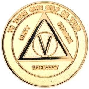 A gold colored medal with the words " unity, courage and recovery ".
