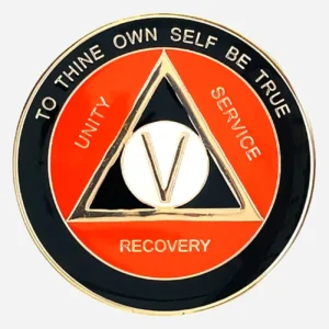 AA Alcoholics Anonymous token in black and orange with gold accents, with the AA triangle symbol and the words "Unity Service Recovery" on the outside of the triangle.