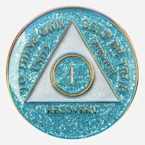 Close-up of the Triplate AA Token Glitter Aqua, showcasing the intricate detailing of the AA symbol and "To Thine Own Self Be True" motto against the sparkling aqua background.